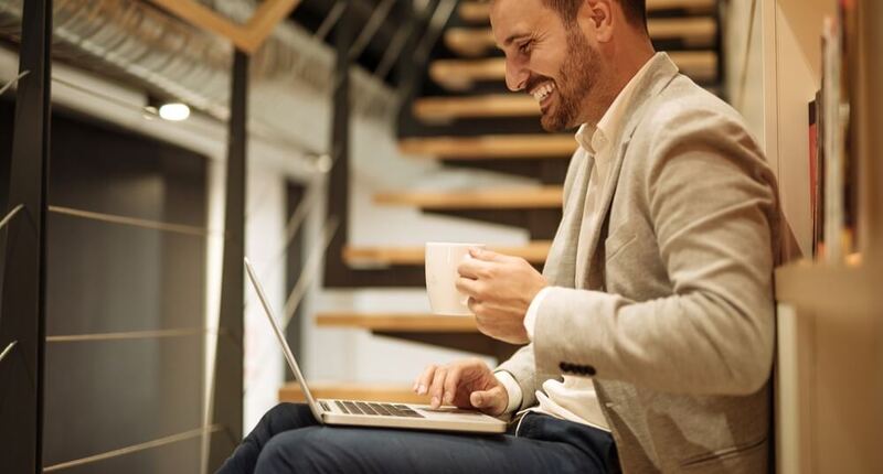 alt = a man using a laptop looking for employment